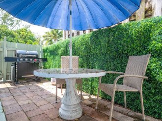 West side yard includes outdoor furniture and a 2nd BBQ grill. This is a shared space with other guests staying at Paradise Shores.