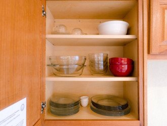 Kitchen cabinets are stocked with everything needed to create and serve a fabulous meal