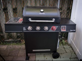 West side yard BBQ grill with propane tank