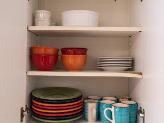 Plenty of colorful plates, bowls and mugs.