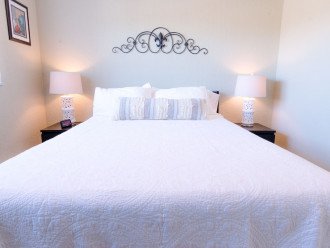 The fully furnished bedroom includes 2 nightstands and a tall dresser. There's plenty of storage for personal belongings.