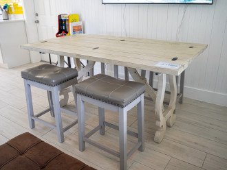 Dining table folded out, barstools.