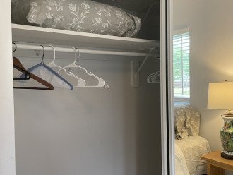Extra pillow and hangers in bedroom closet