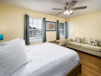 The guest bedroom has 2 large windows and a sleeper sofa