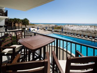 Enjoy a meal while looking over the pool deck and Gulf of Mexico