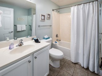 The guest bathroom has a shower/tub combo