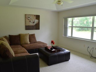 Spacious great room with a large TV and comfy couch