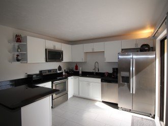 Brand new kitchen with stainless steel appliances and granite countertop