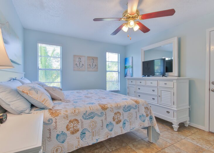 Day side - main bedroom with TV, dresser and half bath