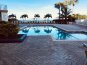 Beautiful palm trees accent the beautiful pool area