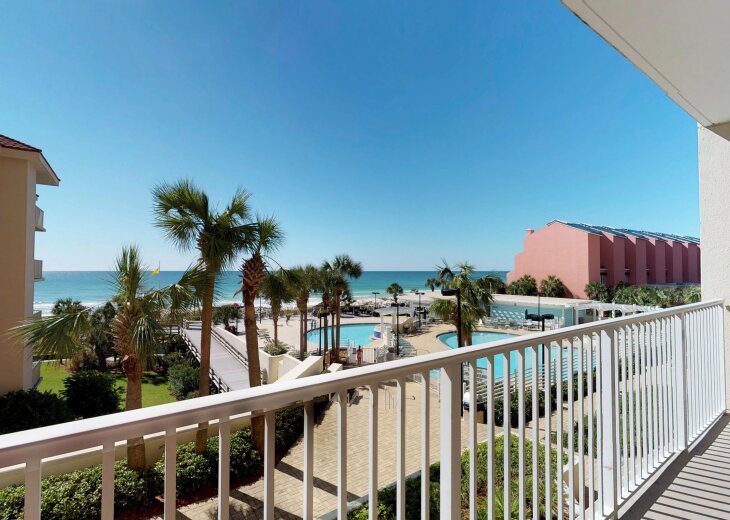 Private balcony overlooking the pools, beach, and Gulf.