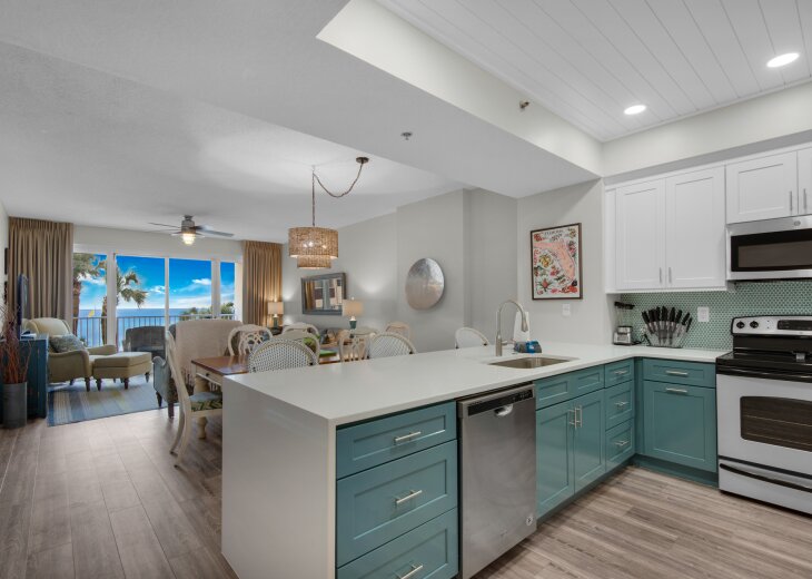 Open kitchen and living area with Gulf views and a TV. Living-room furniture shown has since been replaced.