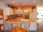 Second Level Kitchen & Dining Room leading to outside deck overlooking pool.