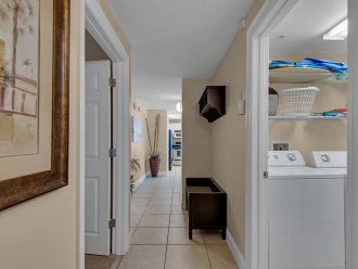 entrance / hallway with laundry room to the left and bag / item nook