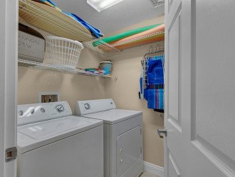 laundry room with beach toys & full-sized washer & dryer