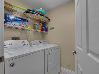 laundry room with beach toys & full sized washer & dryer!