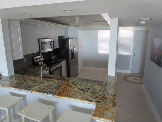 3 bar stools and New granite counters extends Kitchen to Dining area.