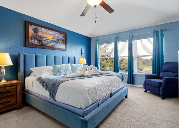 King size primary bedroom with view of lake and Windsor Waterpark.