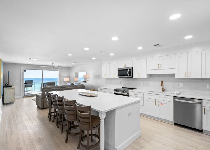 Picture yourself preparing meals in this bright, spacious kitchen while the ocean beckons just beyond the balcony doors—every moment here brings the beach within reach.