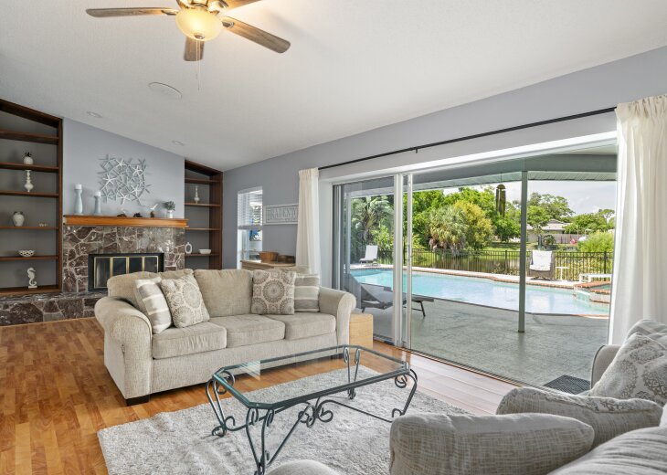 Sink into plush seating and enjoy your private pool right outside the sliding doors. Natural light floods this cozy space, making it the perfect retreat after a sunny day outdoors.