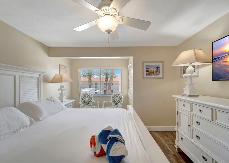 Rest well in the bright primary bedroom at Siesta Beach House #313, a 2-bedroom Siesta Key vacation rental near Crescent Beach. Enjoy a comfortable queen bed, coastal décor, and a peaceful retreat after a day at the beach.