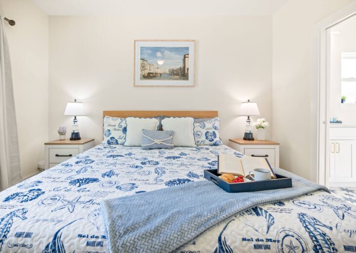 Elegant king suite with en-suite bath, 55" smart TV, and blackout curtains to ensure privacy and comfort.