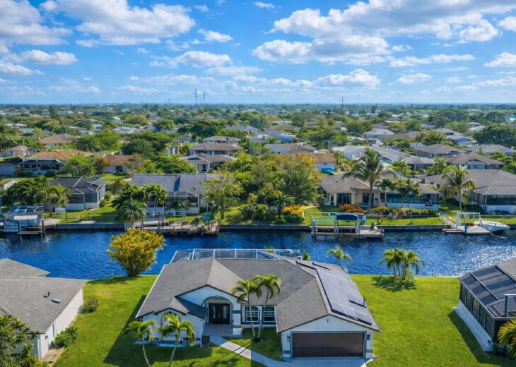 Canal-front retreat with screened pool, solar and serene water views