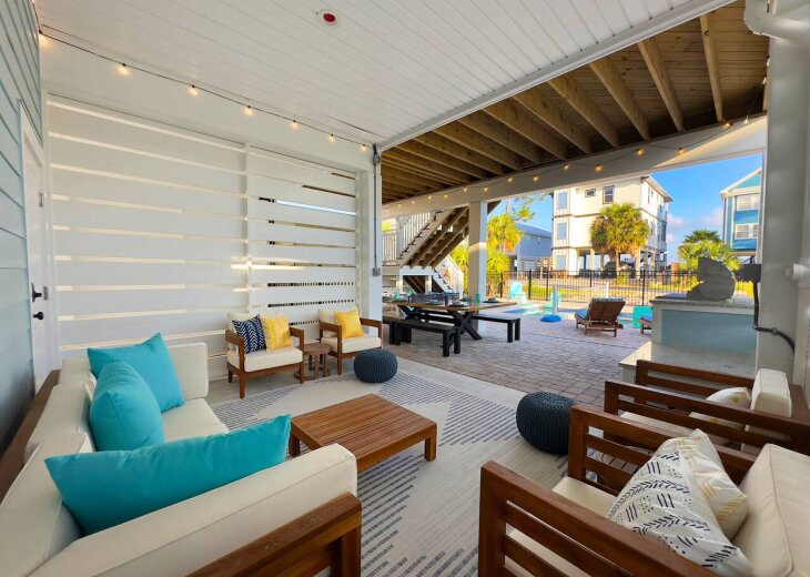 Outdoor seating by the pool and grill to relax and unwind.
