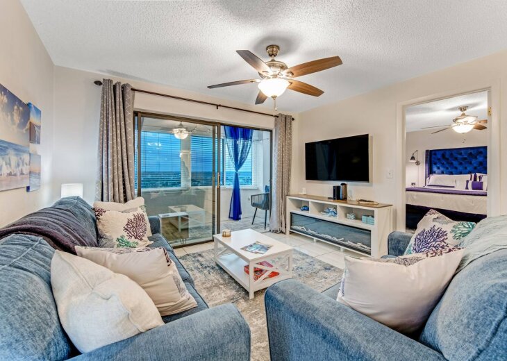 Living Room with 50" Smart TV with cable, internet and fireplace. Queen sized sleeper sofa with easy to move coffee table on casters.