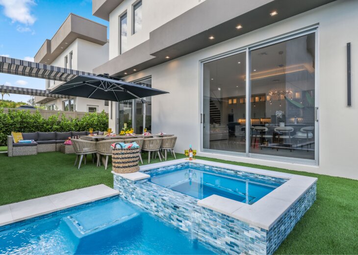Your private Delray Beach retreat begins here: pool, raised spa, outdoor dining, lounge seating, and modern indoor-outdoor living in one luxury backyard.