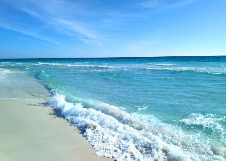 Steps from a stunning turquoise beach with soft sand and gentle waves