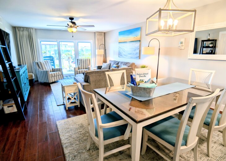 Bright coastal living room with dining space and private balcony access