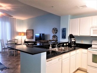 Fully equipped modern kitchen with granite counter tops & lots of counter space