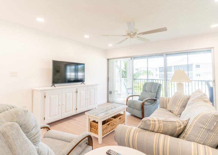 Living area is open to the kitchen and has 2 swivel rockers and comfortable couch.