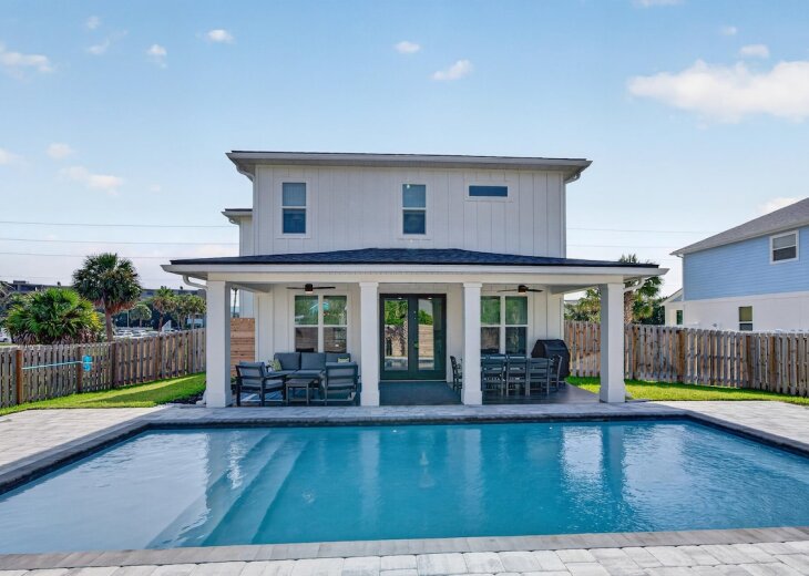 Isola Bella awaits! Swim in the heated saltwater pool or relax under the covered patio - brand-new construction with custom finishes throughout!