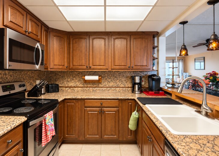 Fully equipped kitchen featuring granite countertops, ample cabinet space, and modern appliances for easy meal preparation.
