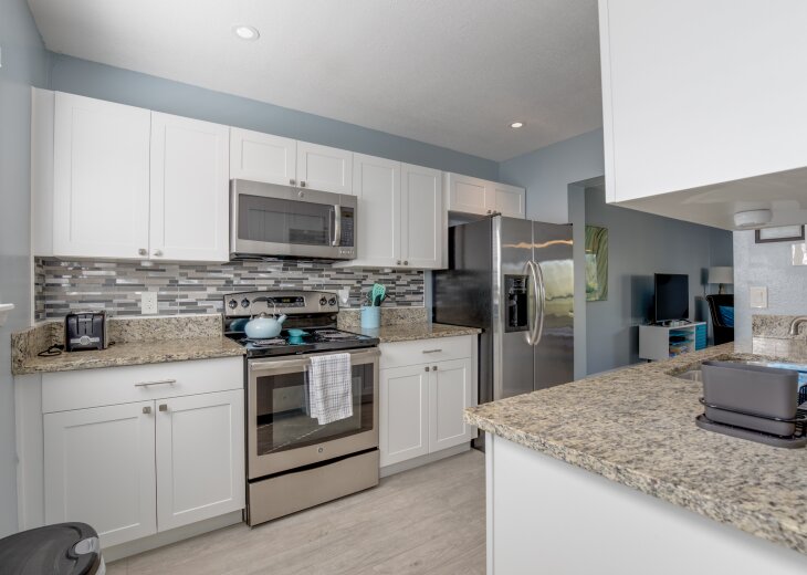 Updated kitchen with stainless appliances and granite