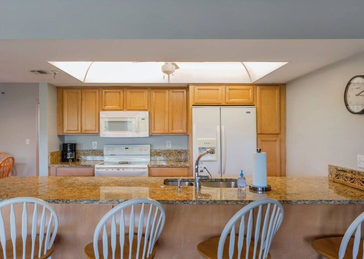 Kitchen with granite breakfast bar seating four