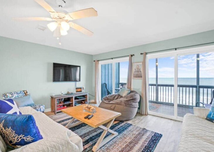 Living room with Smart TV and Screened in Balcony overlooking the water