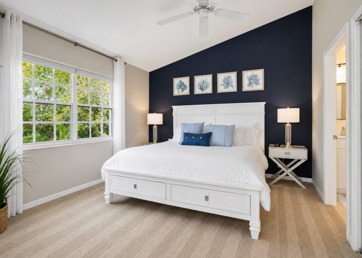 Master bedroom with king bed and walk-in closet.
