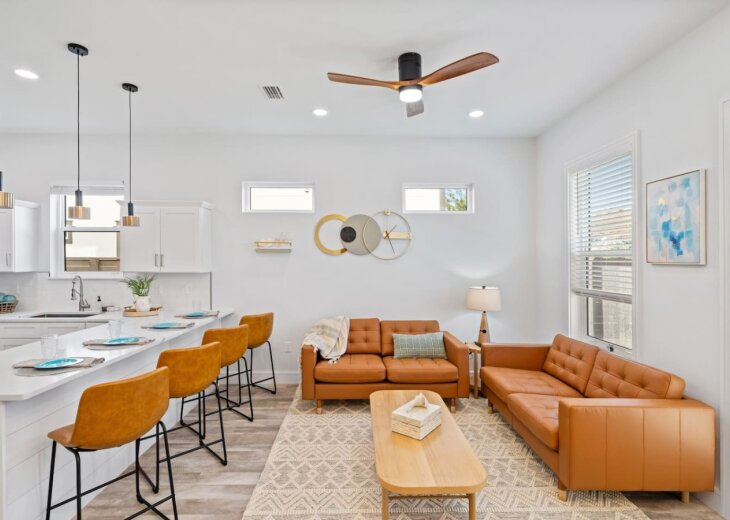 The living room is located just off the kitchen and next to the patio and backyard