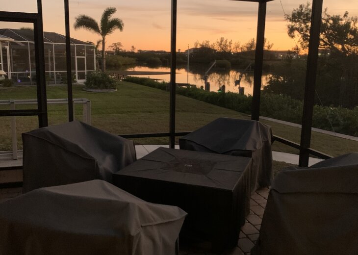 Sunset view from screened lanai and fire table set