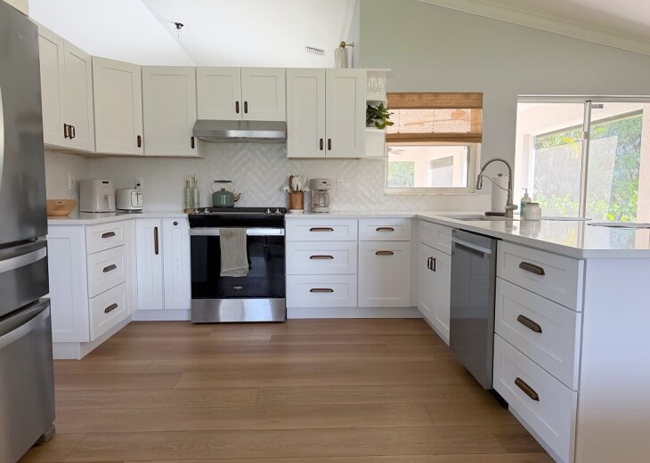 Kitchen with white shaker cabinets and stainless appliances
