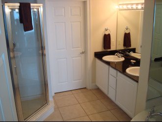 Large master bath with dual vanity, glass enclosed shower & walk-in closet