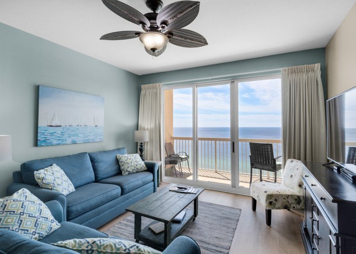 The comfortable living room has excellent Gulf views & walkout private balcony