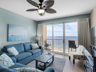 The comfortable living room has excellent Gulf views & walkout private balcony