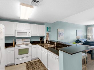 Fully equipped kitchen with granite counters, ceramic cooktop & dishwasher