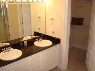 Full size master bath w/ dual vanity, granite counters & a large walk-in closet