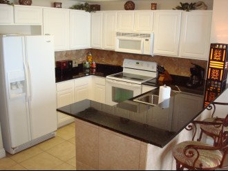 Fully equipped, full size kitchen with granite counter tops & tile back splash