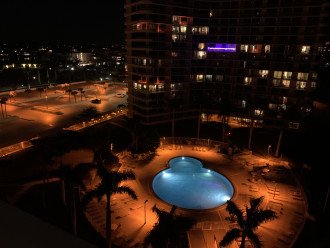 View from balcony overlooking pool area at nigh